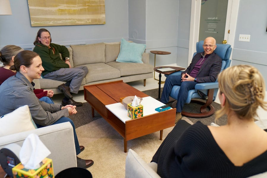 Dr. Rey Junco facilitating an interpersonal process group therapy session in a Concord, MA counseling office.